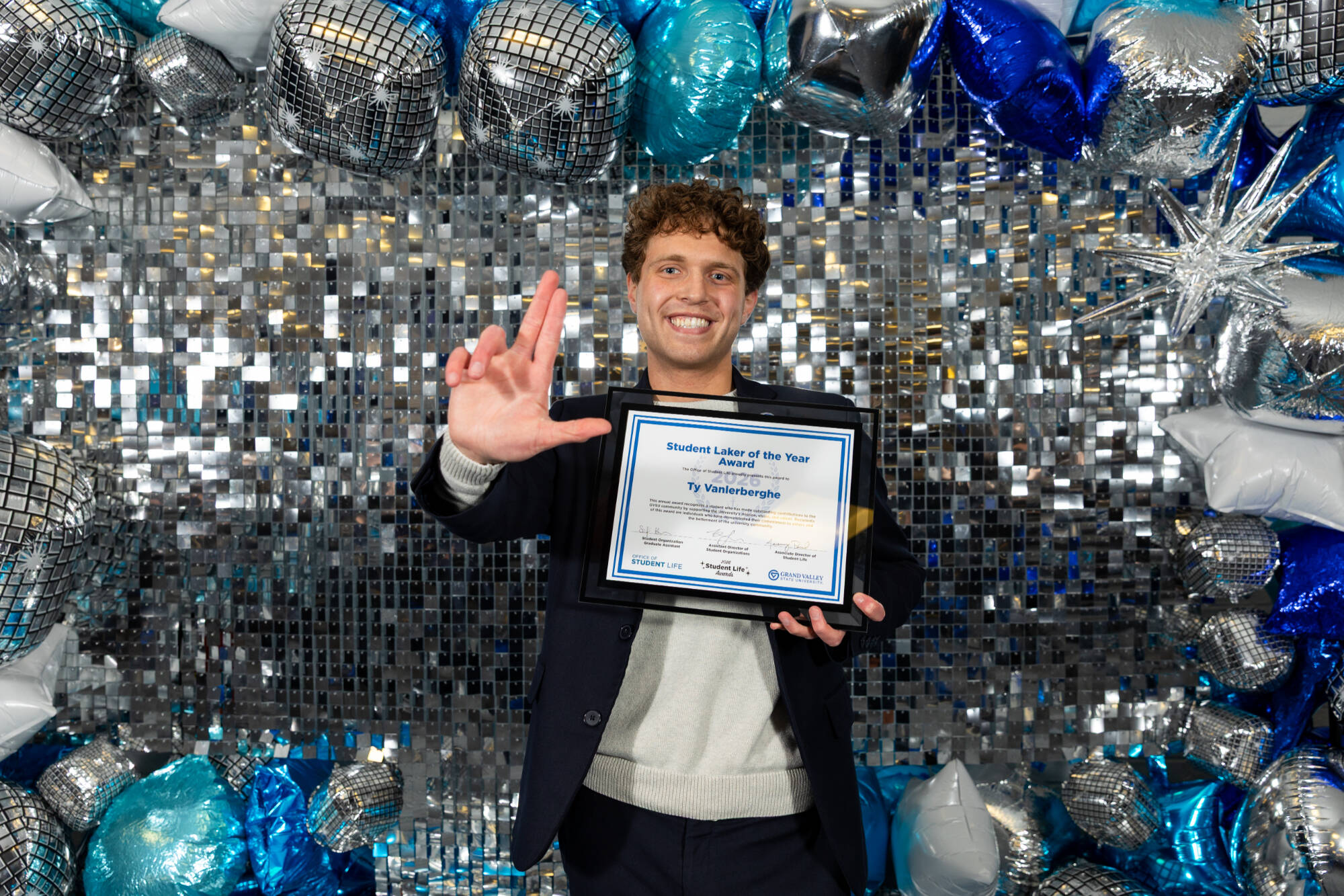 An individual holding an award certificate